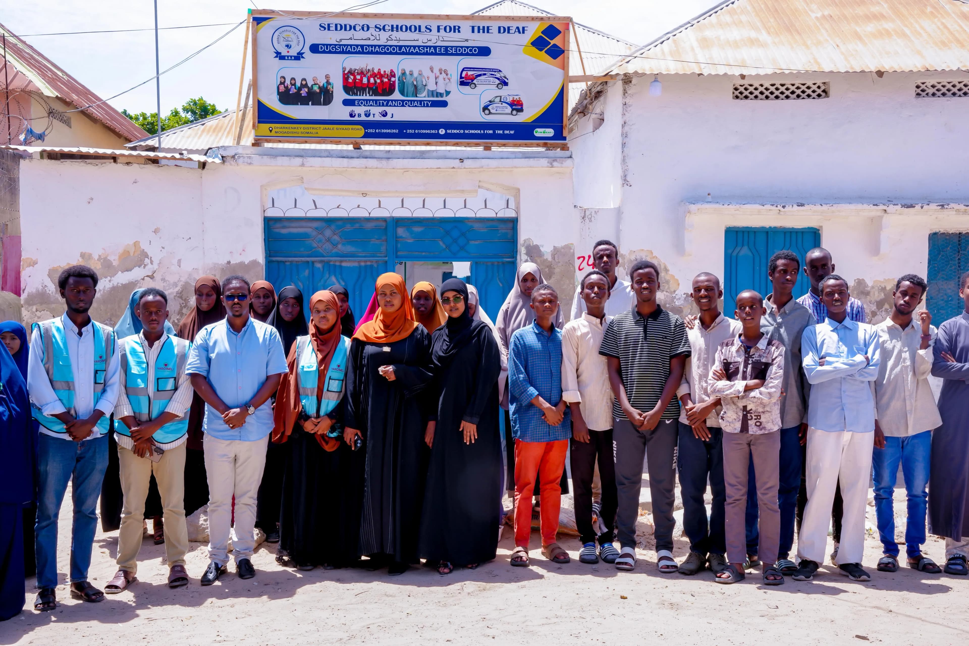 Students, educators and healthcare workers gathered outside SEDDCO Schools for the Deaf in Mogadishu